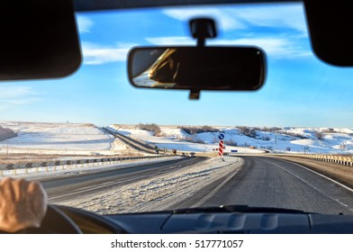 Winter Landscape Background With Winter Road View From Car Interior Driving Men Hand On Control Wheel Windshield Glass Panel Back View Mirror Sunset Scene Detail Exterior Skyline