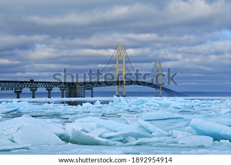 Winter landscape of blue ice shards and the Mackinac Bridge, Straits of Mackinac, Lake Michigan, Michigan, USA