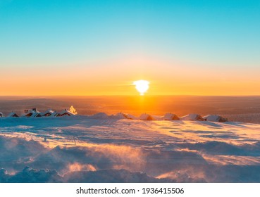 Winter Landscape During Sunset. Colorful Sky Glowing By Sunlight. Dramatic Wintry Scene. Snow Covered Trees Under Warm Sunlight