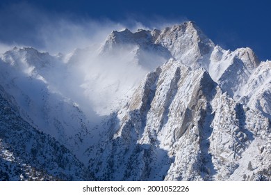 Winter Landscape Of The Eastern Sierra Nevada Mountains Covered In Snow And Framed By A Clear Blue Sky, Near Lone Pine, California, USA