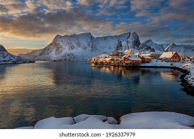 Winter landscape of a fishing village lit by the morning sunlight.