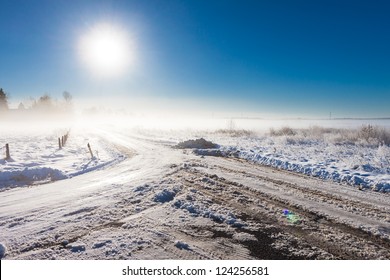 winter landscape at fog  with road near farm
