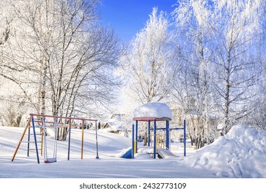 Winter landscape and frosty frost, village, children's playground, swings, Moscow region
 - Powered by Shutterstock