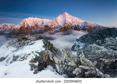 Winter landscape with mountain Krivan in High Tatras illuminated by morning sun