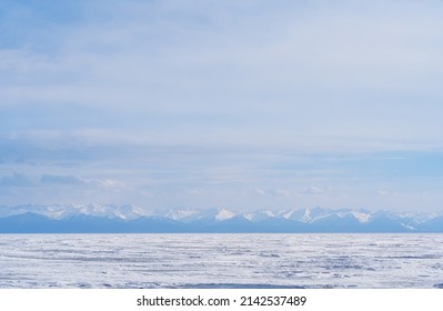 Winter Landscape With Mountains And Lake Baikal In Siberia At Sunset. Natural Background.