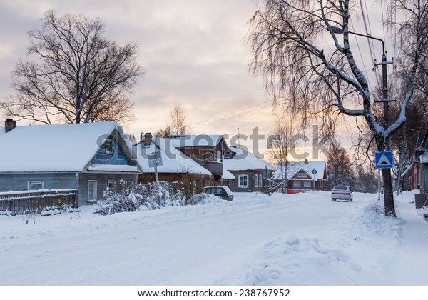 Winter\
landscape in the northern Russian city in evening twilight at\
sunset time. Kargopol city, one of the\
streets