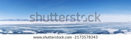 Winter landscape panorama with mountains and Lake Baikal in Siberia on sunny day. Natural background.
