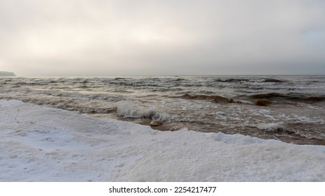 winter landscape from the seashore, lying pieces of ice on the seashore, sand and ice texture in the dunes, Baltic Sea, Latvia in winter - Shutterstock ID 2254217477