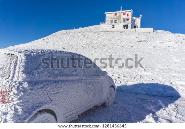 Winter landscape of the shelter of Velouchi\
mountain in Karpenissi, Evritania, Greece. A frozen car outside the\
shelter