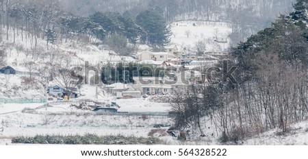 Winter landscape of a small community on the side of a mountain covered in snow