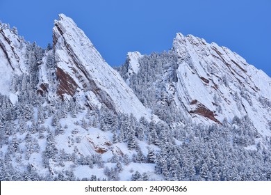 Winter landscape of the snow flocked Flatirons at dawn, Rocky Mountains, Boulder, Colorado, USA