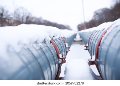Winter landscape with the snow-covered gas pipeline and trees in hoarfrost. Gas pipe transite snow winter.