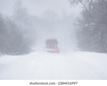 Winter landscape. A snowplow clears a snow-covered road. Bieszczady Mountains. Poland