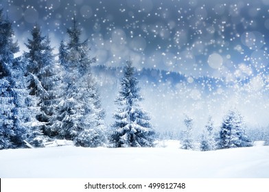 Winter landscape with snowy trees and snowflakes. Christmas concept - Shutterstock ID 499812748