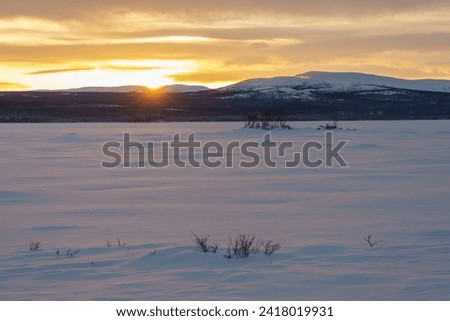Winter landscape at sunset  in Jokkmokk county, Swedish Lapland, Sweden