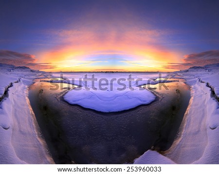 winter landscape sunset on the ice of the river and the city on the horizon