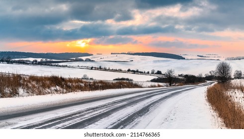 Winter Landscape With Sunset Sky And Empty Snowy Road.