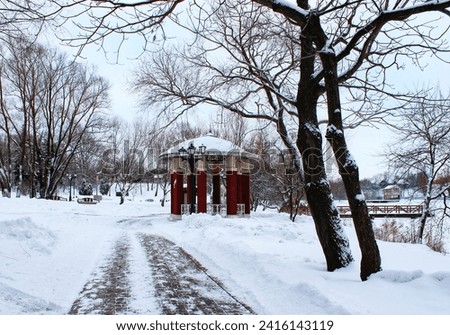 winter landscape, walk in the park on a frosty day, beauty of nature, atmosphere, red brick gazebo, trees in white snow, on the lake shore, park architecture