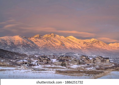 Winter Landscape Of Wasatch Mountains And Houses In Utah Valley At Sunset