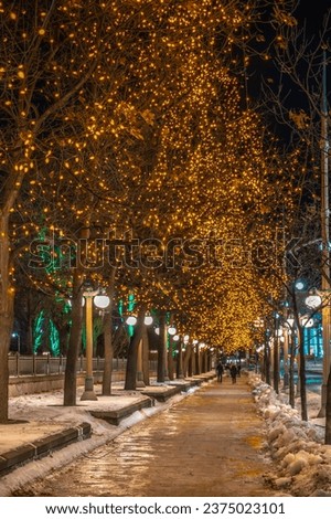 Winter lights across Canada: festive gold Christmas lights on Mackenzie Avenue behind the historic Fairmont Chateau Laurier hotel during holidays, Ottawa, Ontario. Photo taken in December 2021.