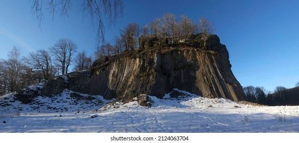 Winter in the Lusatian mountains in the north of the Czech Republic. Basalt rock Zlaty vrch. Volcano rock formation Zlaty vrch built pentagonal and hexagonal basalt columns.  - Shutterstock ID 2124063704
