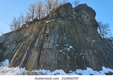 Winter in the Lusatian mountains in the north of the Czech Republic. Basalt rock Zlaty vrch. Volcano rock formation Zlaty vrch built pentagonal and hexagonal basalt columns.  - Shutterstock ID 2124063707