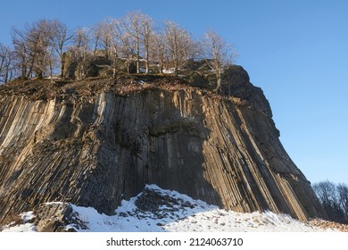 Winter in the Lusatian mountains in the north of the Czech Republic. Basalt rock Zlaty vrch. Volcano rock formation Zlaty vrch built pentagonal and hexagonal basalt columns.  - Shutterstock ID 2124063710