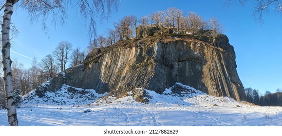 Winter in the Lusatian mountains in the north of the Czech Republic. Basalt rock Zlaty vrch. Volcano rock formation Zlaty vrch built pentagonal and hexagonal basalt columns.  - Shutterstock ID 2127882629