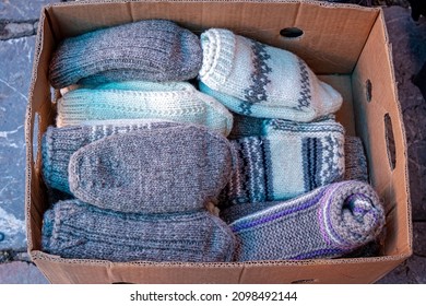 Winter merino wool socks pile inside cardboard box sold on market