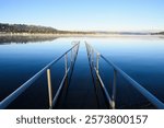 Winter morning path leading into the calm smooth water of Lake Sammamish