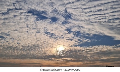 The Winter Morning Sky Was Filled With White, Gray And Orange Clouds. 