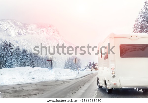 Winter mountain road landscape with\
campervan turning aside. Family vacation travel, holiday trip in\
motorhome. Beautiful austrian nature\
scene