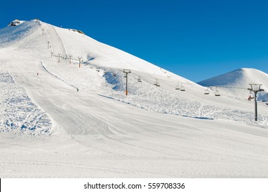 Winter mountains background with ski slopes and ski lifts. Skiing resort. Extreme sport. Active holiday. Free time concept.