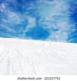 Winter Mountains Snow Slope And Blue Sky Background