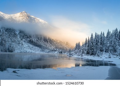 Winter mountains at sunrise. Amazing snowy nature landscape in sunlight. Scenery mountain clean icy lake in the morning. Beautiful wild scene in frosty highlands - Powered by Shutterstock