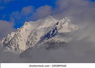 Winter mountains surrounded by clouds.