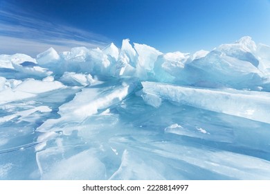 Winter natural background and fragments blue ice   heaps pieces ice floes Lake Baikal sunny frosty day  Abstract cold background  mock up  Harsh lifeless environment