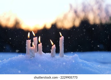 winter nature background with burning candles. candles in snow, magic winter evening scene. Christmas, New Year Holidays, Yule sabbat concept. witchcraft ritual. - Powered by Shutterstock