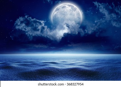 Winter night sky with full moon, cold weather with snow. Elements of this image furnished by NASA - Powered by Shutterstock