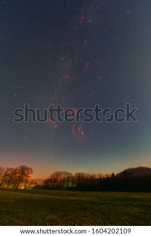 Winter night sky including Barnard’s Loop, the Orion Nebula, the Flame Nebula, the Rosette Nebula, the California Nebula, and the Pleiades as seen from Lampenhain in Germany.