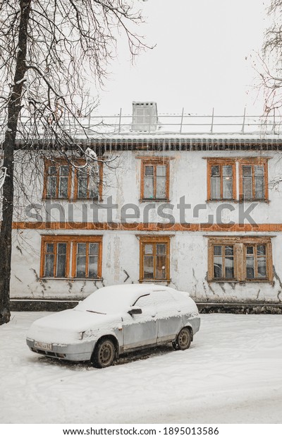 \
Winter in an ordinary Russian city.\
A simple\
Russian car stands under the snow near a wooden house built in\
1940-1960.\
Icicles, snow, trees, frost.\
City after a snowfall.\
Russian town after a\
snowfal