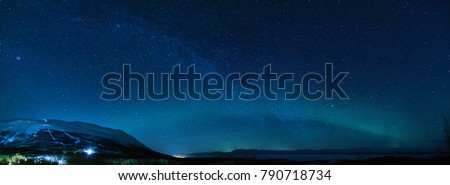 Winter panorama with Milky way and Northen lights phenomenon starting Aurora Borealis in Lapland scandinavia.