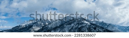 winter panorama in reutte tirol with a view of duerrenberg, kohlberg and saeuling with a cloudy sky in spring