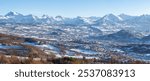 Winter panoramic view of the city of Gap with distant mountain peaks of Ecrins National Park. Hautes-Alpes, Alps, France