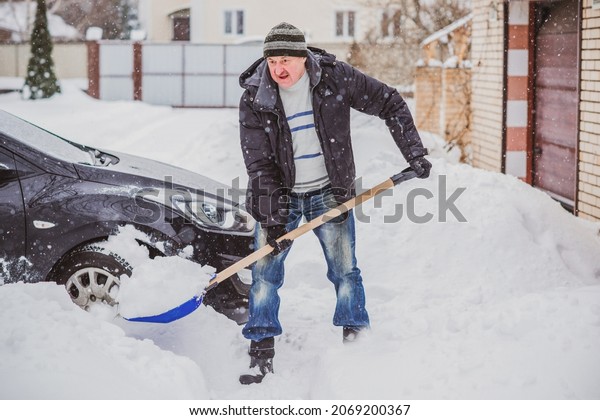 Winter, people and car problem concept. Man stuck\
in the snow. Mutual aid. Winter problem. transportation, winter and\
transportation concept