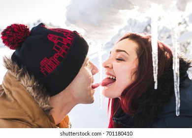 Winter Photo Of Young Happy Couple Licking An Icicle