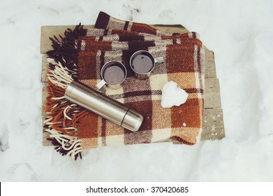 Winter Picnic On The Snow. Hot Tea, Thermos And Snowball Heart On Cozy Warm Blanket. Outdoor Seasonal Activities.