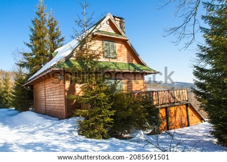 Winter in Poland. Typical mountain wooden village house in Beskidy mountains in winter season, Koszarawa, Beskidy Mountains, Poland