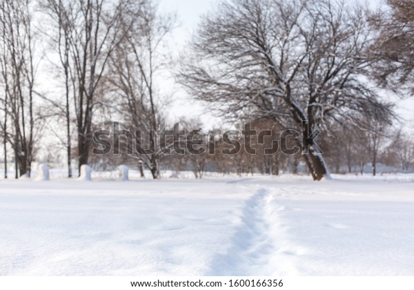 Winter poorly cleared\
road. Road in the countryside strewn with snow. Winter landscape\
with snowdrifts.