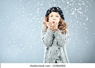 Winter Portrait Of Cute Little Girl Wearing Warm Cozy Clothes Studio Shot With Snow